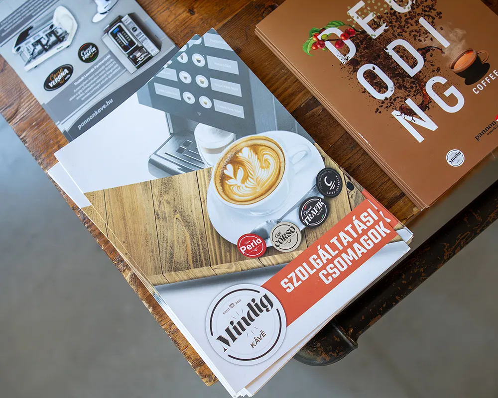 Flyers and coffee brochures on a table, seen from above